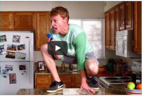 Video of a man kneeling on his kitchen counter screaming.